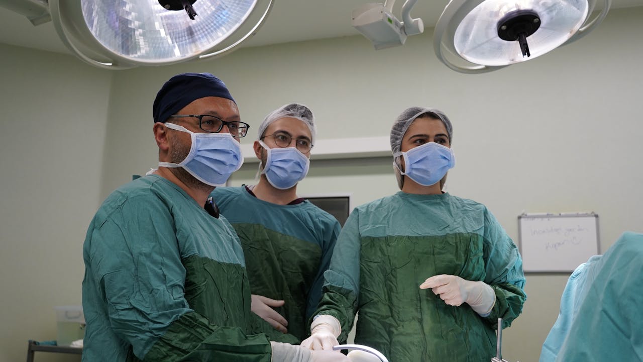 three doctors in an operating room